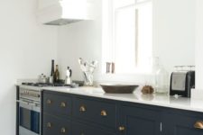 06 brass handles make the cabinets stand out and a stainless steel cooker looks not so bold