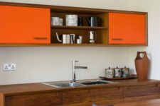 06 saturated natural wood looks chic with bold orange surfaces in this modern space