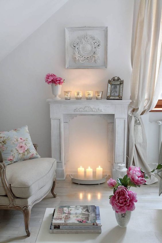 warm up your space with a faux fireplace with candles inside it and on it