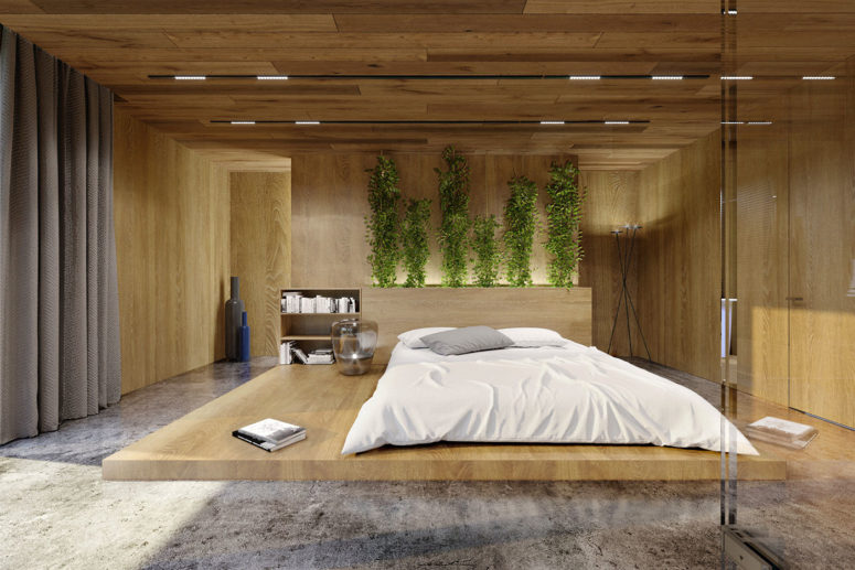 The master bedroom is done with concrete, oak panels, greenery and lots of lights