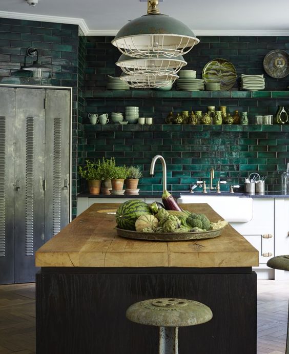 a dark green tile backsplash is extended on the whole wall, and green lamps echo it