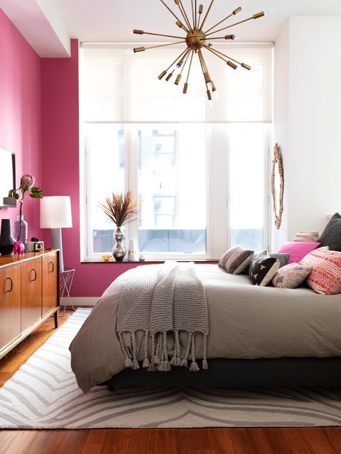 a girlish bedroom with a hot pink wall to make it look more playful