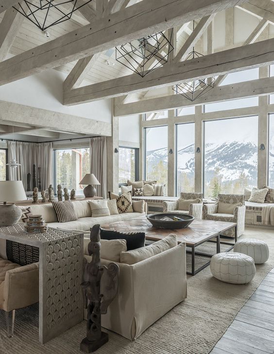 a neutral open space with a high vaulted ceiling with whitewashed beams