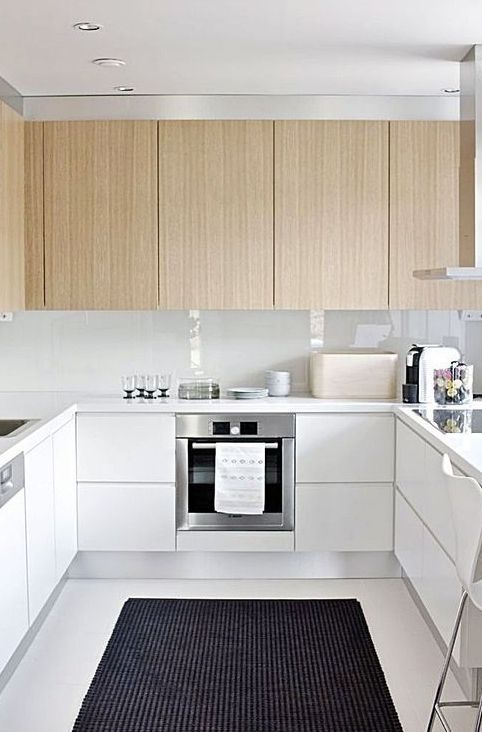 Make your U shape kitchen more eye catchy with light colored hanging cabinets and white ones