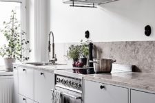 08 a Scandinavian kitchen with black touches, a stone backsplash and counters looks ethereal