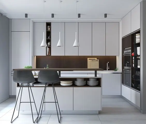 a modern white kitchen with a dark wood backsplash and a kitchen island with storage