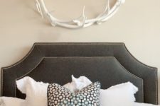09 a cute antler wreath over the bed is a cool way to add a cozy feel to your space