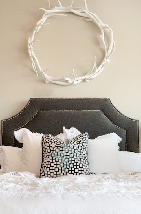 a cute antler wreath over the bed is a cool way to add a cozy feel to your space