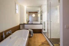 10 The shower is double, and there’s a vanity with a mirror, a large bathtub looks very welcoming