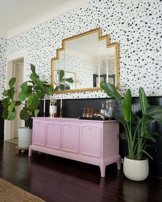 a light pink sideboard makes a colored statement in this art deco space