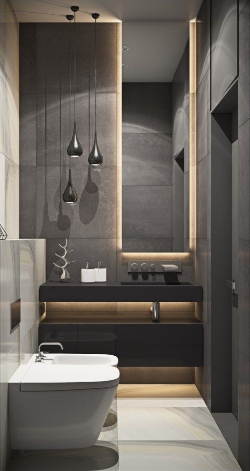 a moody modern bathroom with grey tiles, a black vanity, black pendant lamps and lit up furniture