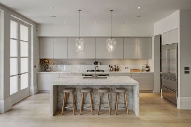 modern dove grey kitchen with white parts, a white kitchen island and a marble backsplash looks luxurious