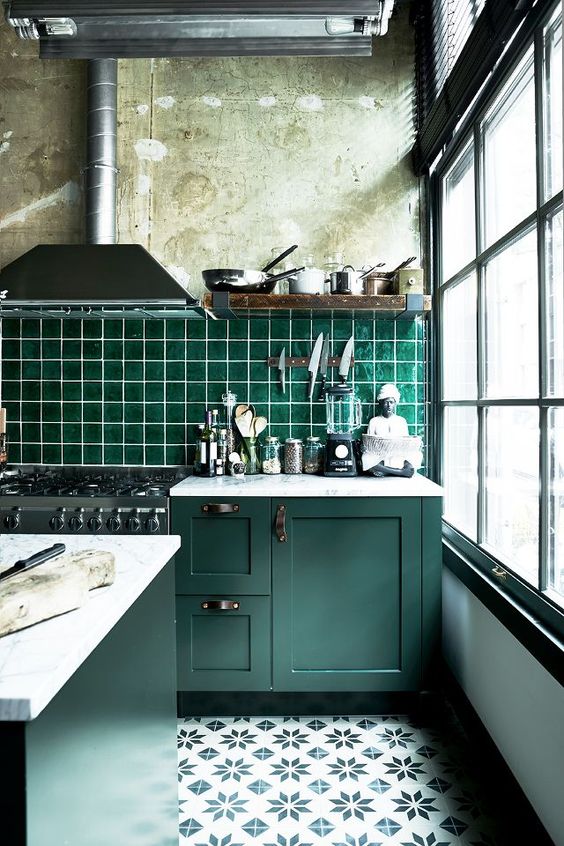 vintage dark green cabinets with industrial handles and an emerald tiles backsplash