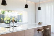 11 a modern light-colored kitchen with a wooden kitchen island and marble counters