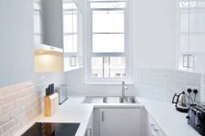 11 a tiny yet very functional minimalist white kitchen with a U shape