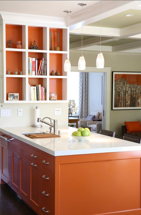 a burnt orange kitchen island and lining of the shelf for a cheerful touch