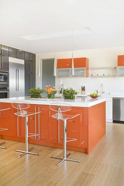 a burnt orange kitchen island and some cabinets spruce up a neutral grey and white space