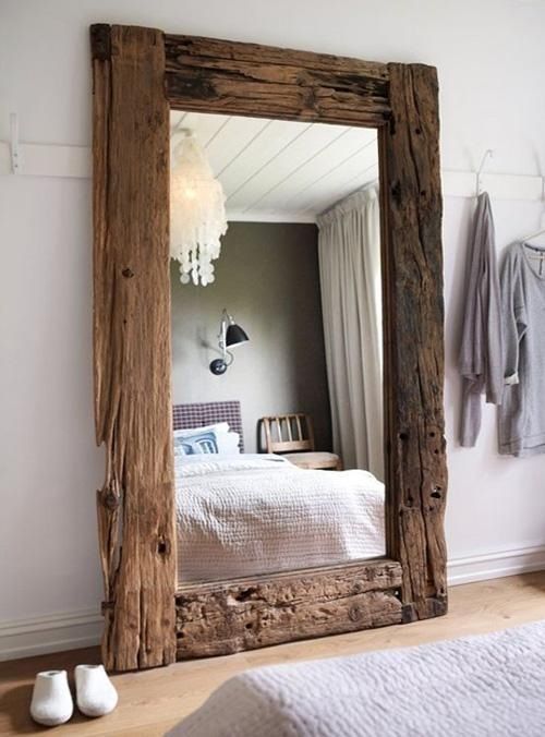a large mirror with a reclaimed wood frame is a real chic statement that catches an eye and brings coziness
