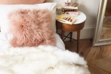 13 a pink faux fur pillow and a white blanket to add a girlish feel and comfort to the bedroom