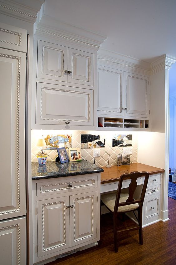 kitchen desk area with traditional cabinets used for document storage