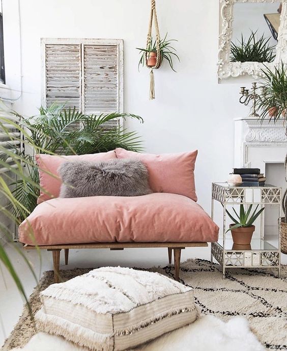 a chic loveseat with pink upholstery makes a colorful statement in the space