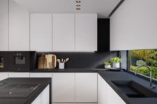 14 a modern space with white kitchens with matte black counters and a backsplash, no handles and additional lights