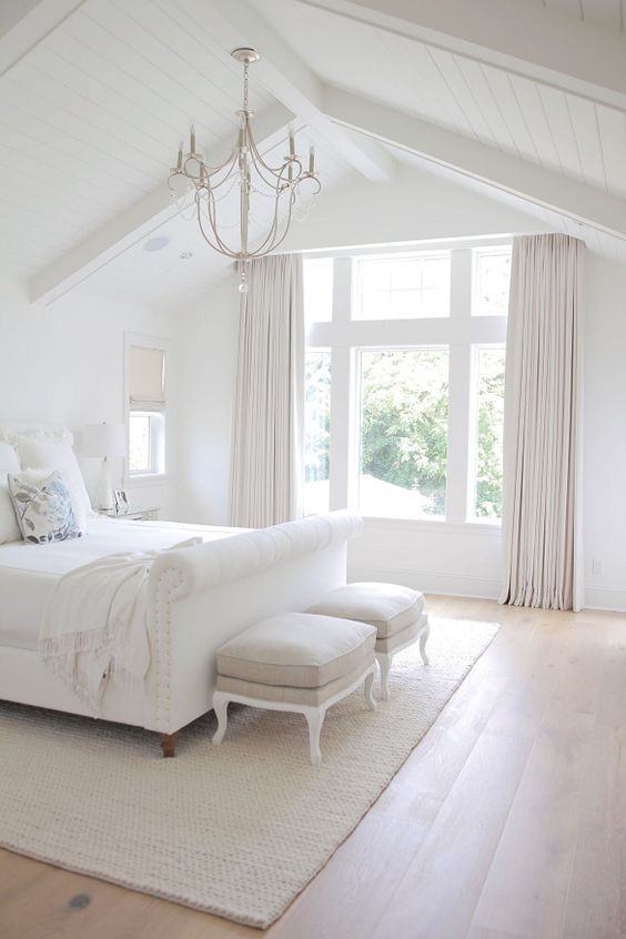 a whitewashed wood covered ceiling perfectly fits this airy bedroom