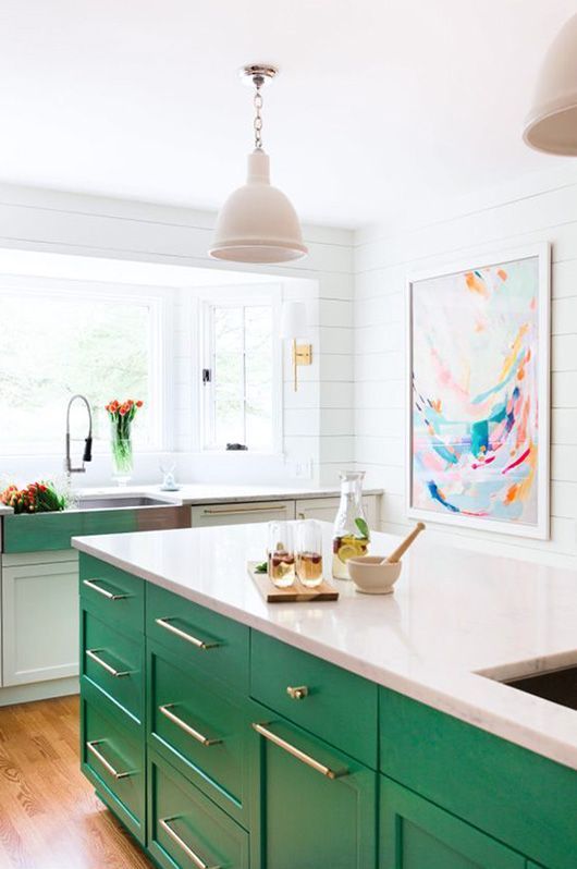 a bold green kitchen island stands out in a neutral space and makes it more cheerful