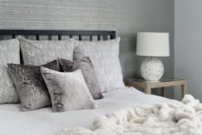 16 a grey bedroom with a white faux fur blanket that makes it more luxurious