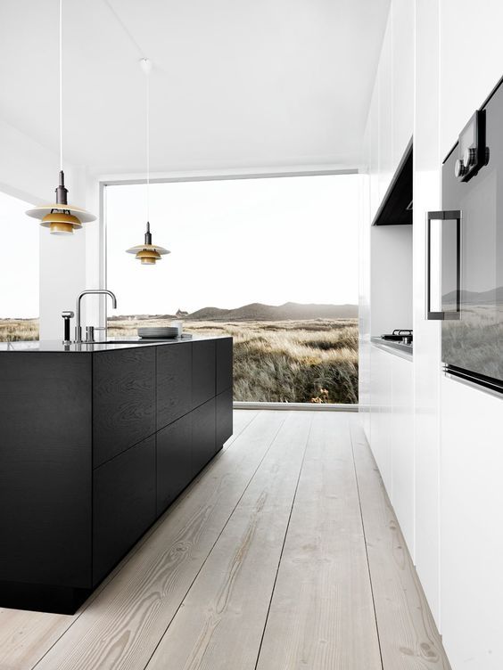 a modern black and white space with a panoramic window, wooden floors and a niche