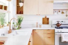 17 a light-colored wooden L-shaped kitchen with copper details looks warm and very welcoming