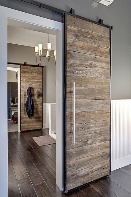 a reclaimed wood sliding wood door looks modern and rustic at the same time