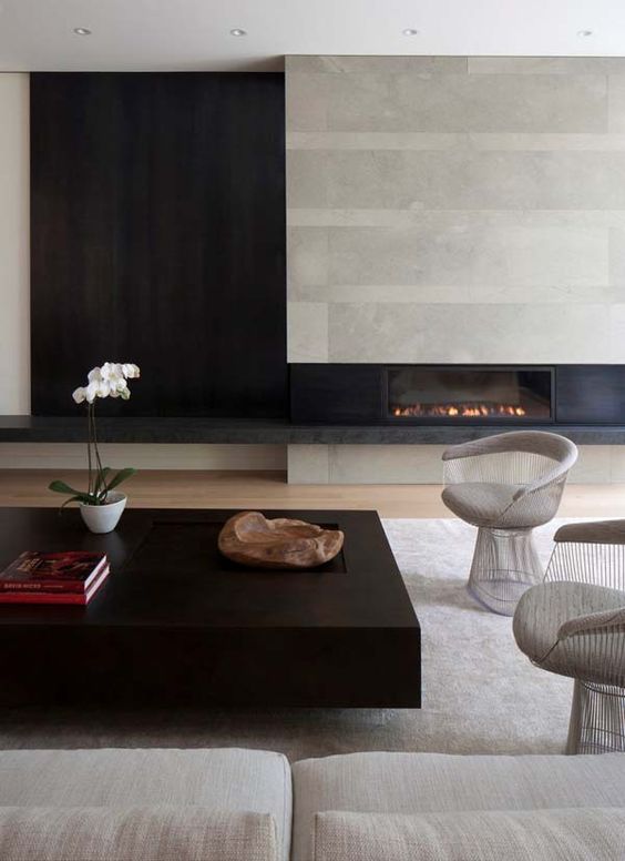 modern aesthetics with concrete, black wood, various textiles and a chic coffee table