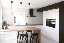 18 a black and white kitchen with wooden counters looks bold and modern