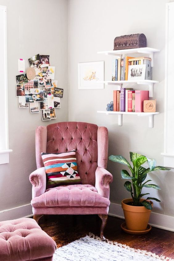 a pink velvet armchair with a footrest can become a nice base for a reading nook