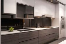 19 a contrasting kitchen with white and wooden cabinets and a sleek black glass backsplash