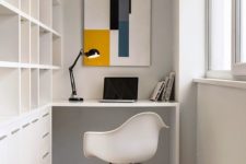 19 a minimalist home office with a large built-in shelving unit and desk