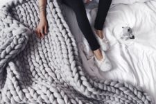20 a grey chunky knit blanket will add warmth and a textural touch to your bed