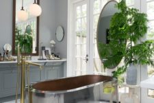 20 a large metal tub is the main eye-catcher in this space, and brass touches are additional