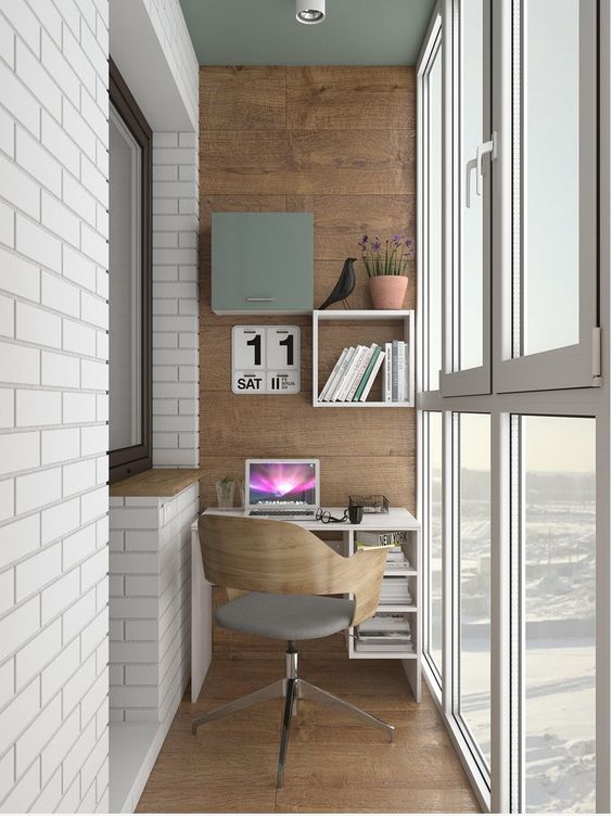 an industrial home office with a small desk, built-in shelves and a modern chair