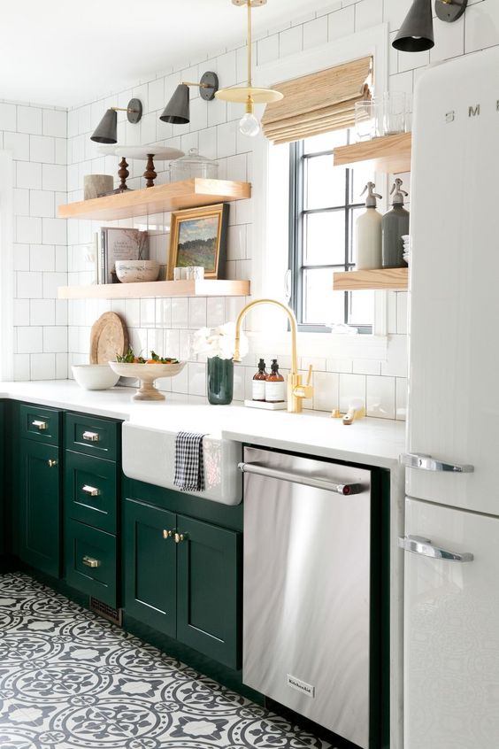 bold emerald cabinets add a colorful touch to this neutral space and contrast the white tiles