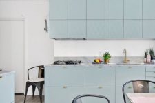 21 a beautiful aqua-colored kitchen with lots of cabinets and whitewashed wooden floors for a light feeling