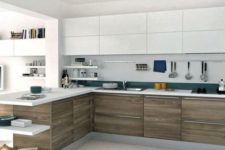 21 a bold white and wood L-shaped kitchen with teal touches and bookshelves to divide the spaces