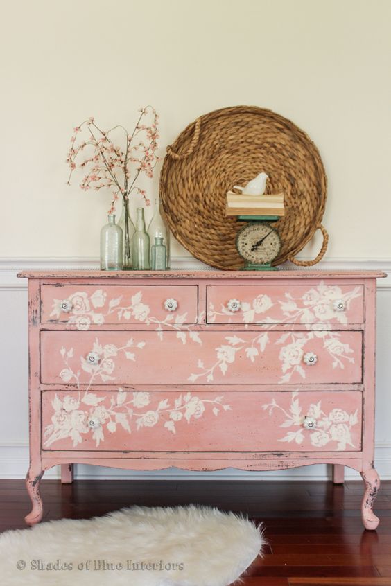 a refined vintage pink sideboard with white floral stencils for a sophisticated touch