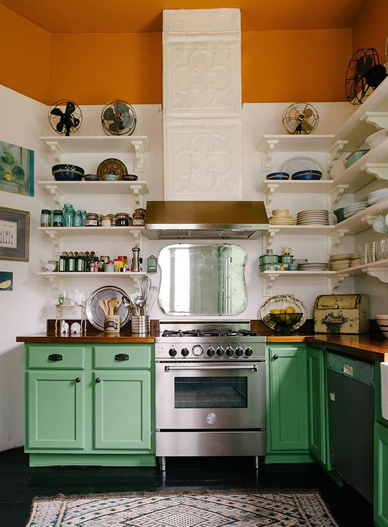 bold green cabinets and an orange ceiling raise the mood