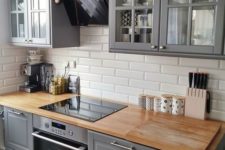22 a vintage grey kitchen with wooden countertops and white subway tiles
