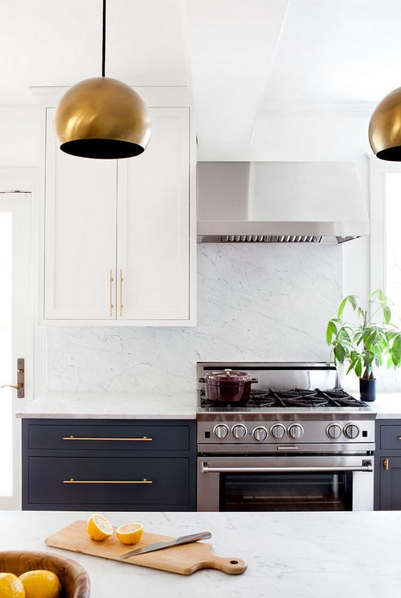 bold copepr lamps and handles take over the stainless steel cooker and hood