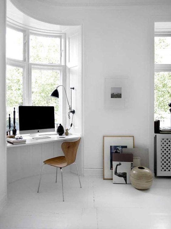 a Scandinavian bedroom windowsill is used as a home office space