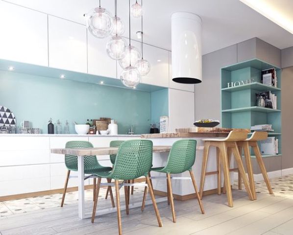 A chic kitchen with white cabinets and blue backsplash, green chairs and eye catchy bubble pendant lamps
