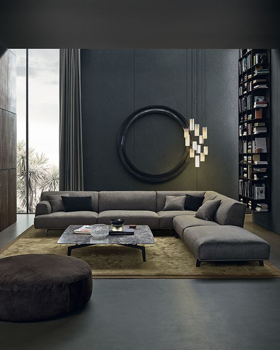 a moody living space with dark walls, cool lights cluster and comfy textural textiles